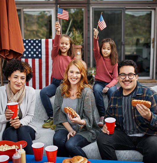 Family celebrating the Fourth of July with a backyard barbecue