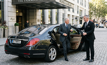 Chauffeur opening the door of a black sedan