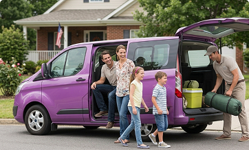 Family loading luggage into a private van